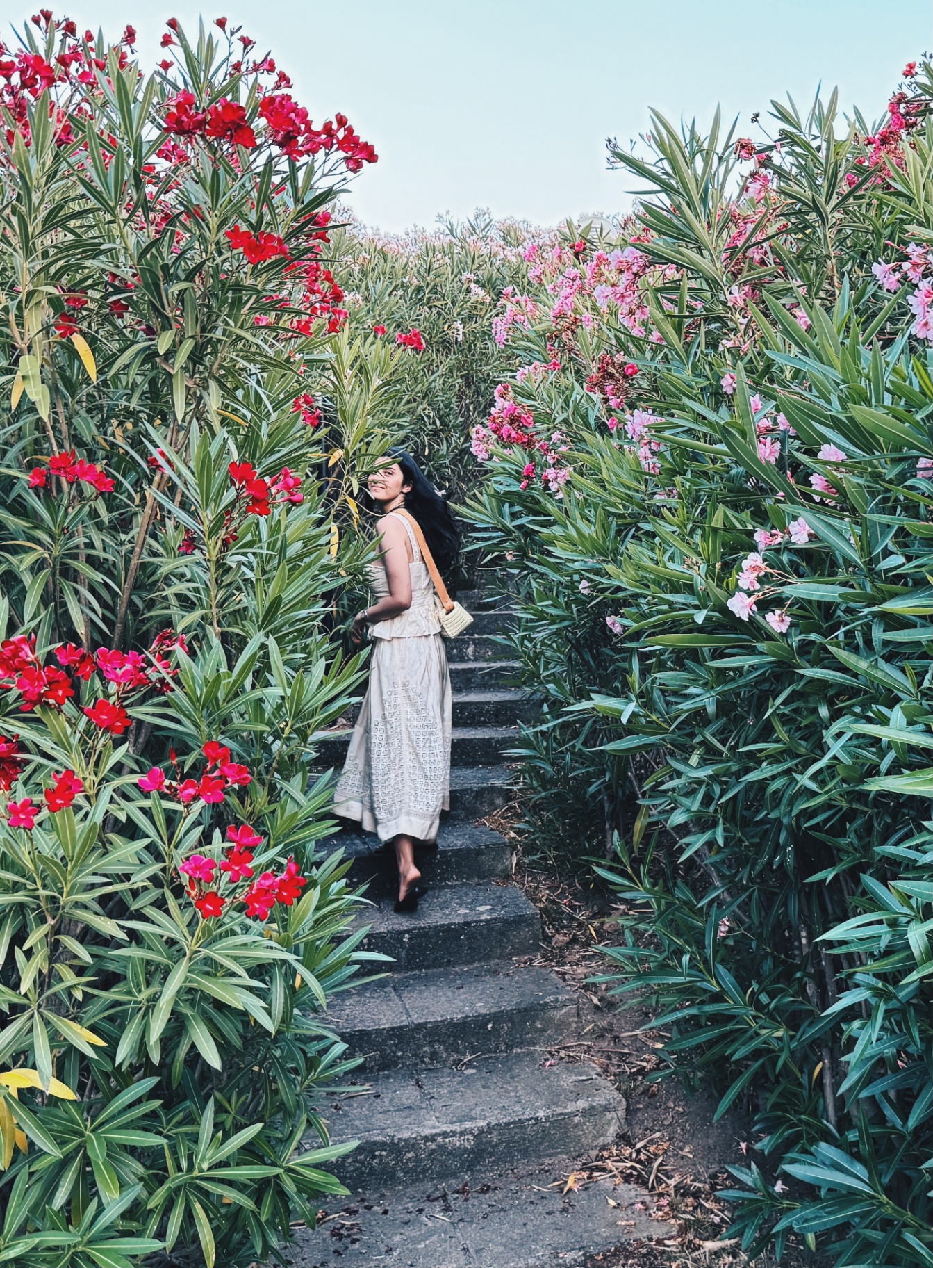 Juliette Quinn on a flower-lined stairway
